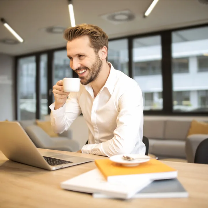 Smiling entrepreneur working on a laptop